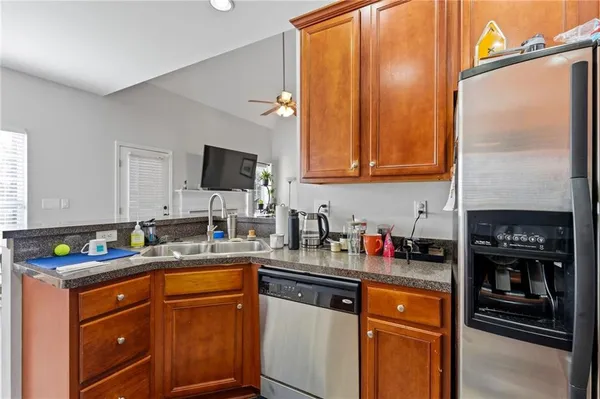 a kitchen with stainless steel appliances granite countertop a stove a sink and a microwave