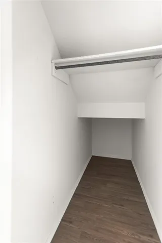 a bathroom with a toilet sink double vanity and mirror