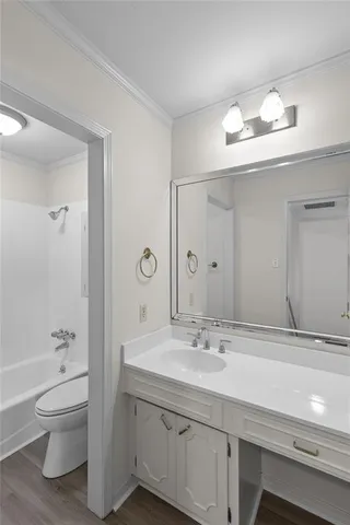 a bathroom with a toilet sink double vanity and mirror