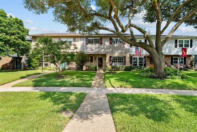 a front view of a house with a yard table and chairs