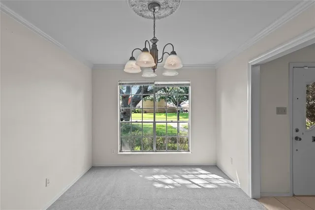 a view of a hallway with wooden floor and chandelier
