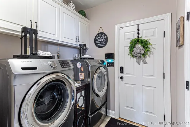 a view of a storage and utility room with washer and dryer