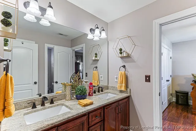a bathroom with a granite countertop sink a large mirror and a shower