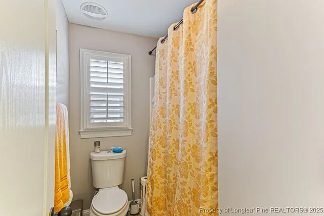 a white toilet sitting next to a bathroom sink