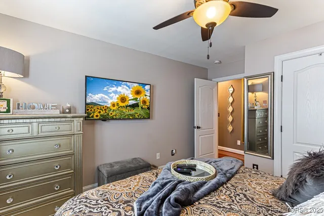 a bedroom with a bed and glass wall
