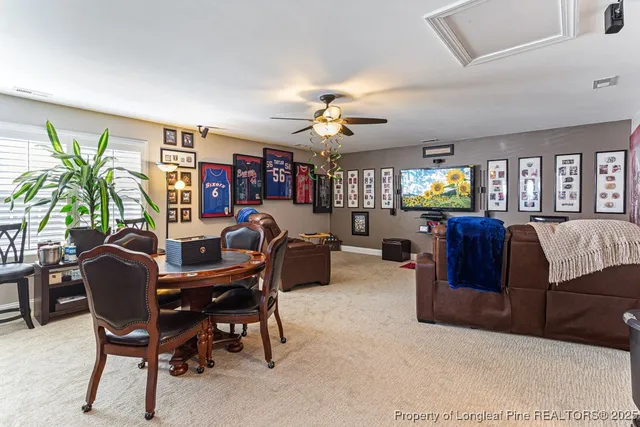 a living room with furniture a chandelier and a bookshelf