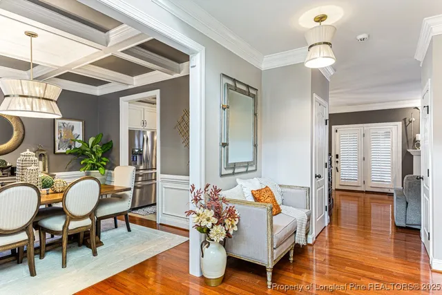 a living room with furniture a wooden floor and a chandelier
