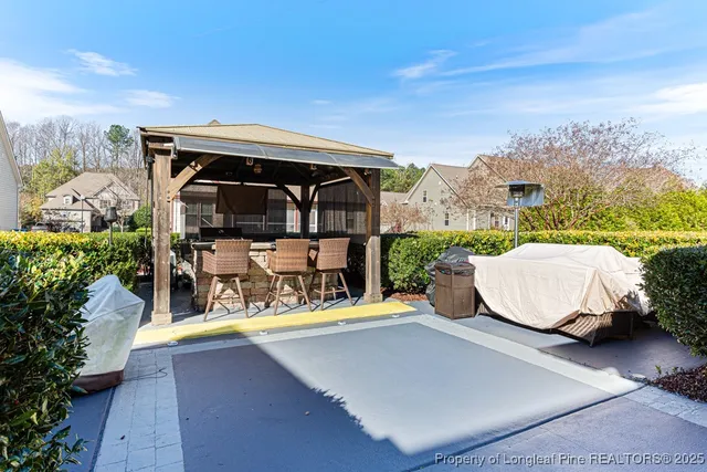 a view of roof deck with a barbeque and wooden stairs