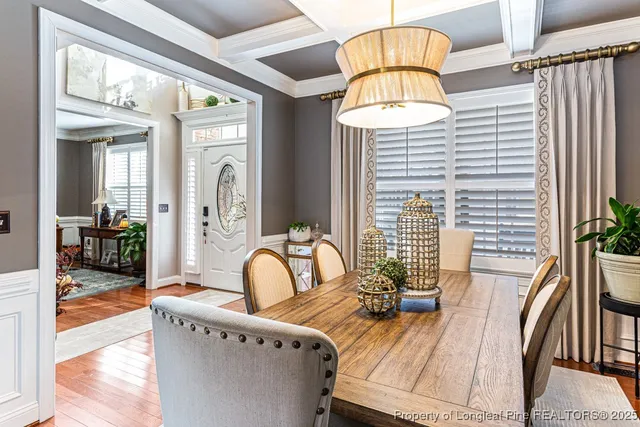 a view of a patio with table and chairs potted plants with wooden floor