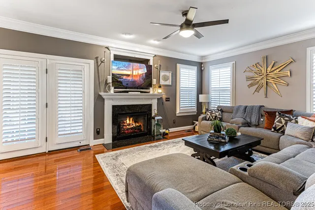 a living room with furniture a flat screen tv and a fireplace