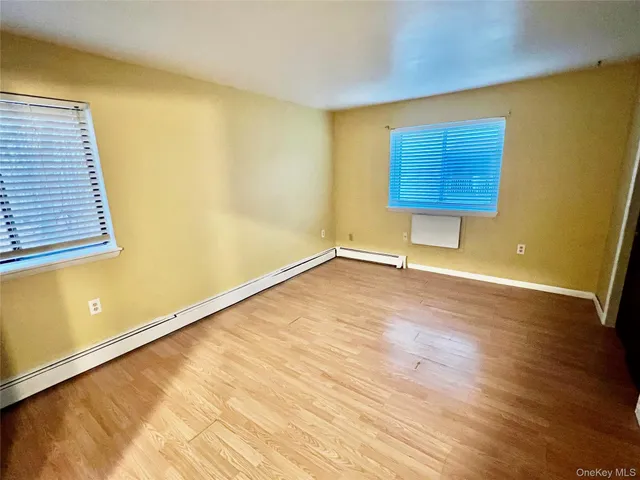a balcony with a couch and a potted plant