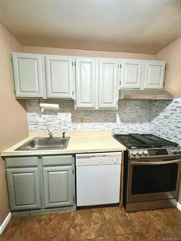 a kitchen with cabinets and stainless steel appliances