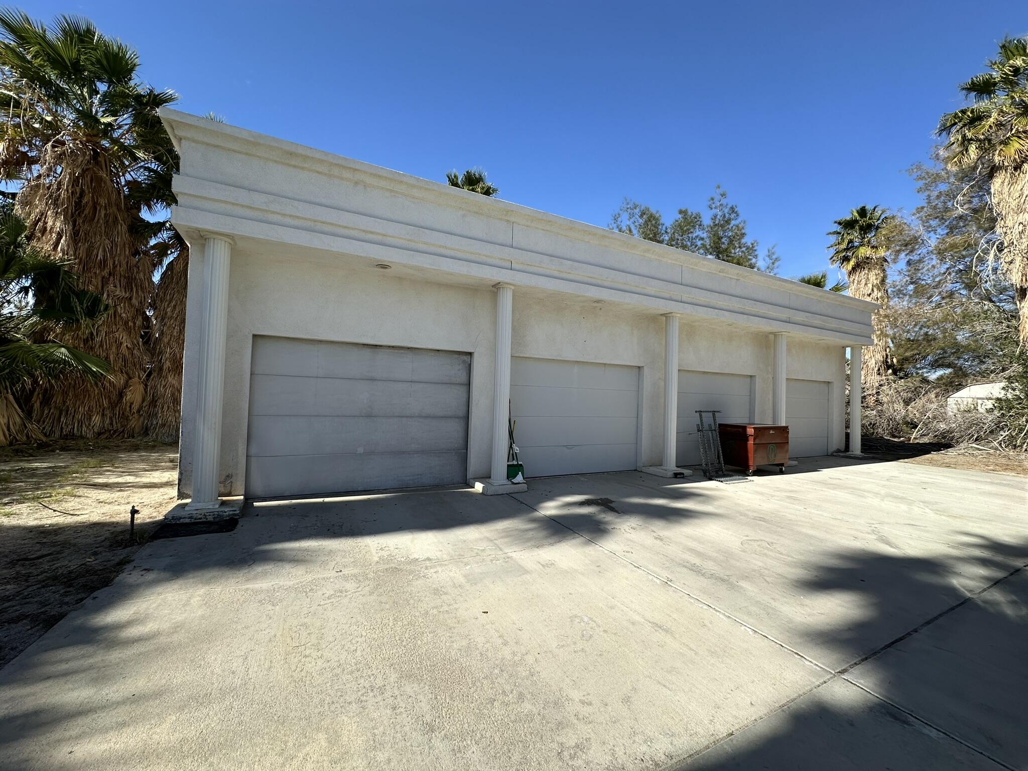39200 Dillon Road Indio, CA 92203 - Photo 18 of 22 a view of yellow house with garage and a barbeque