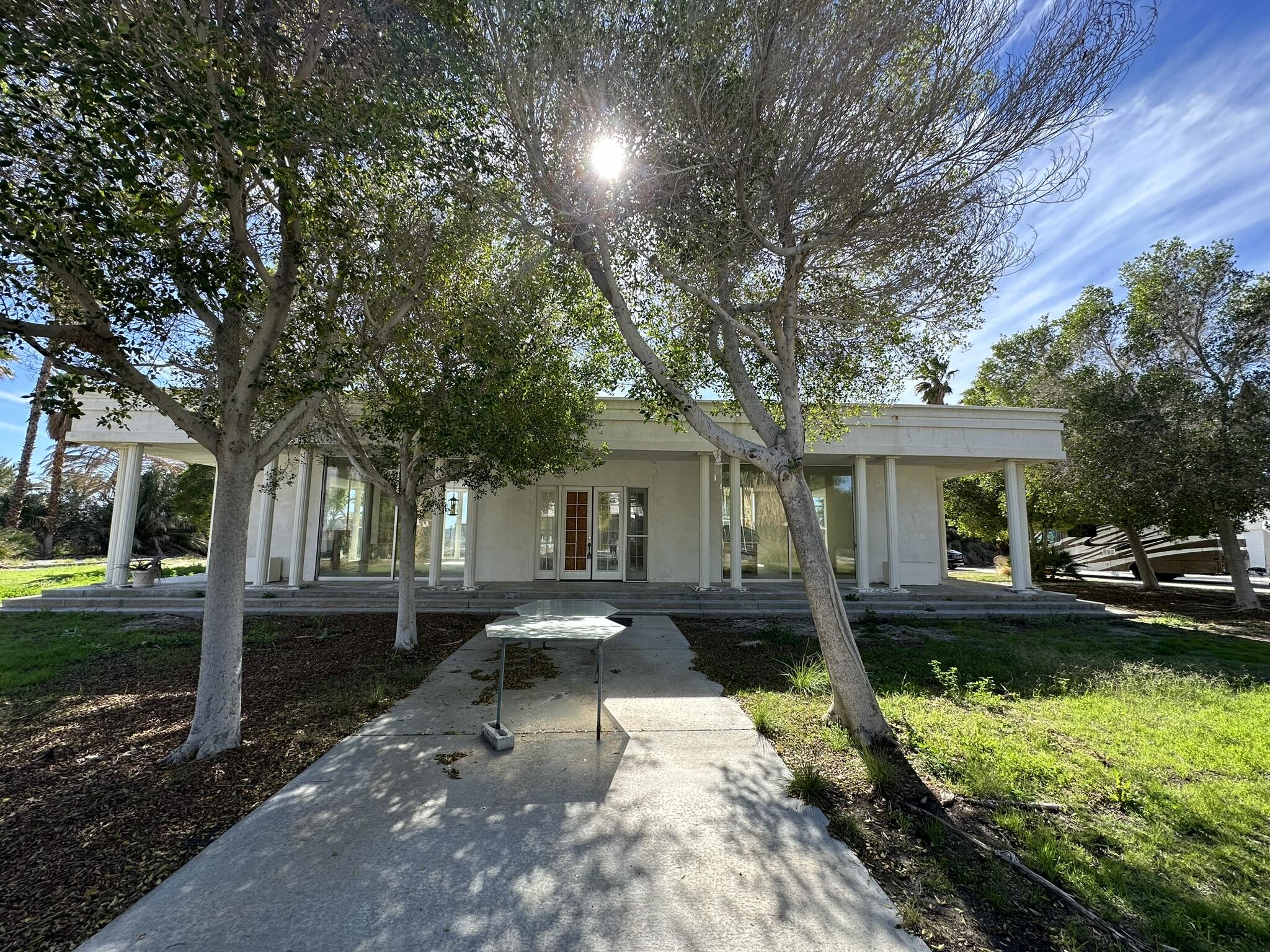 39200 Dillon Road Indio, CA 92203 - Photo 9 of 22 a front view of a house with a yard table and chairs