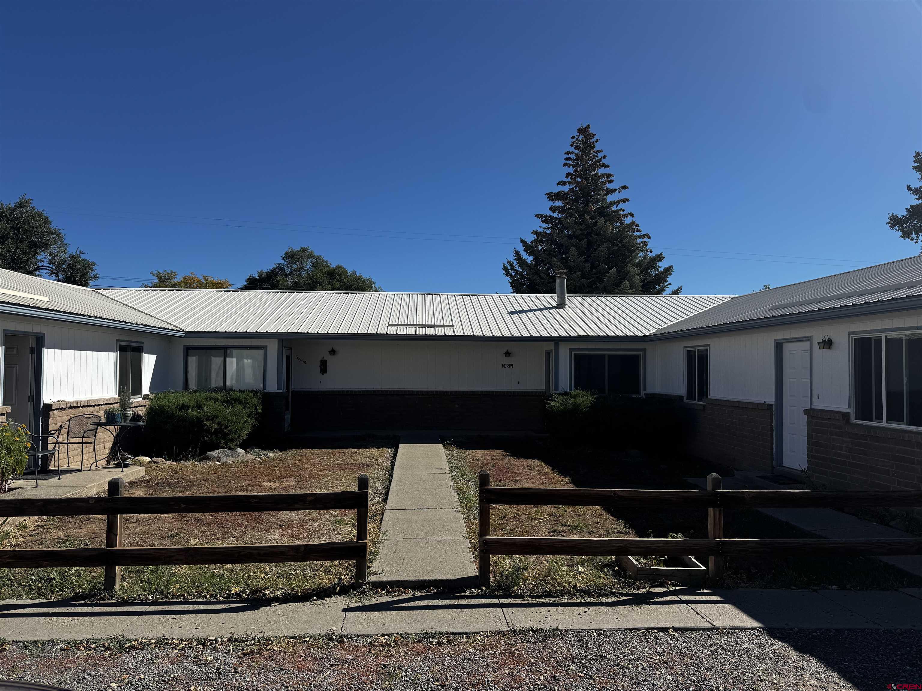 345 1/2 Northwest 4th Street Cedaredge, CO 81413 - Photo 1 of 28 a front view of a house with garden