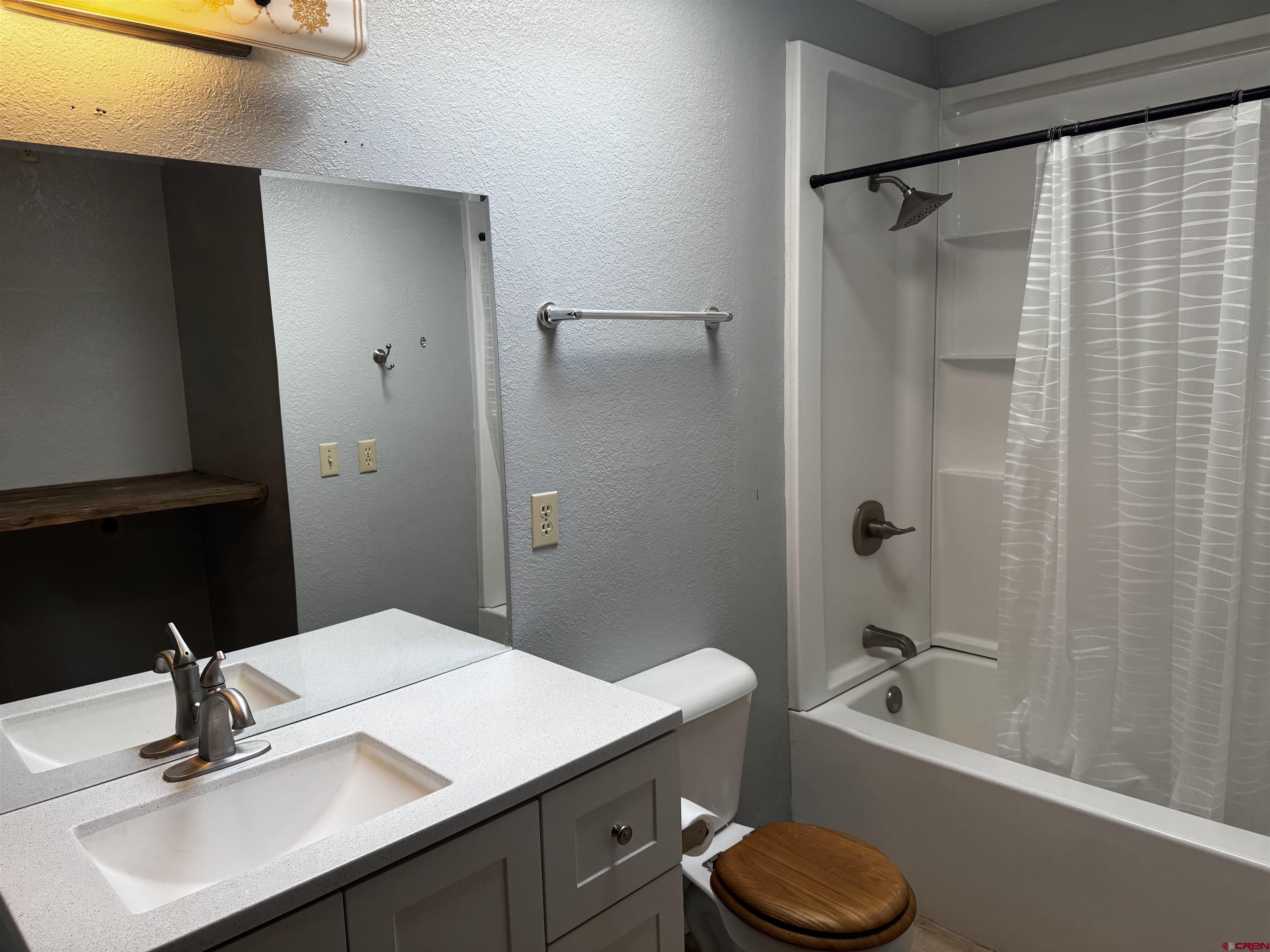 345 1/2 Northwest 4th Street Cedaredge, CO 81413 - Photo 15 of 28 a bathroom with a sink toilet and shower