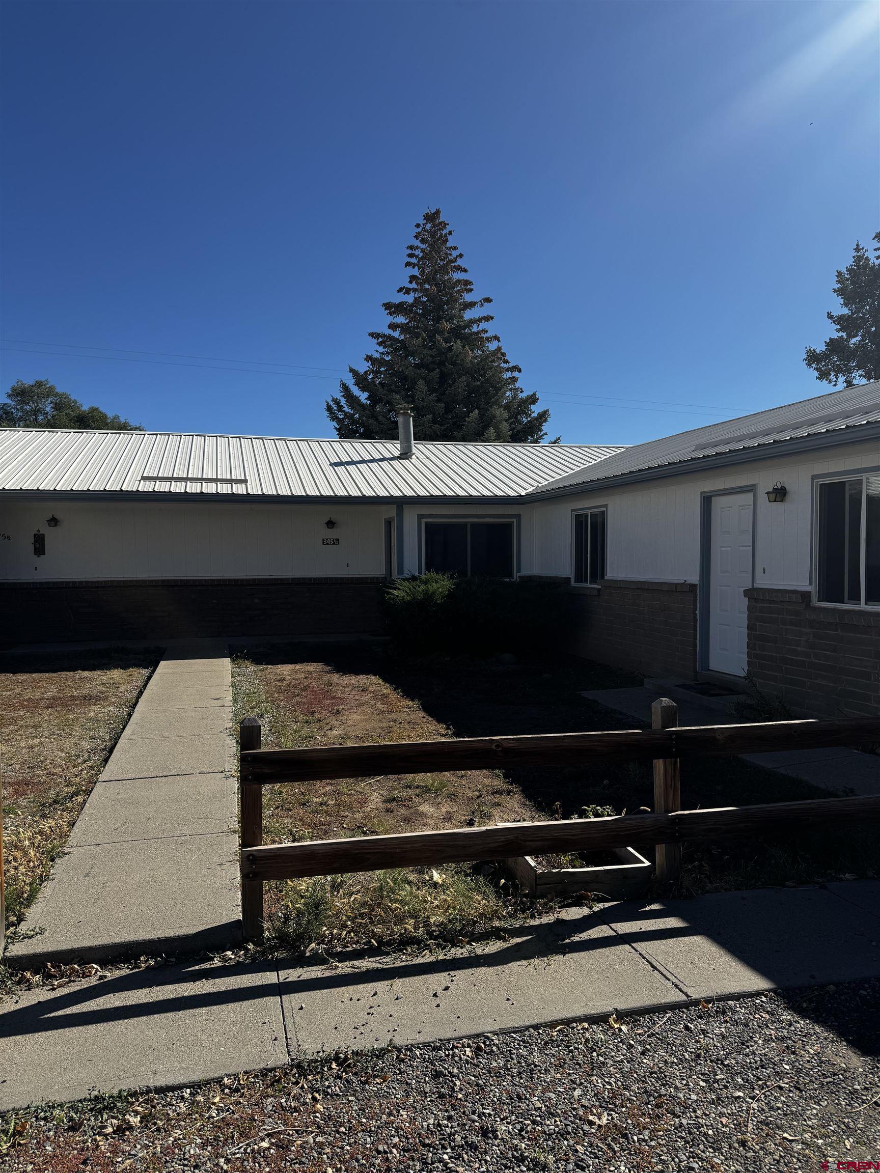 345 1/2 Northwest 4th Street Cedaredge, CO 81413 - Photo 2 of 28 a black white building with black door