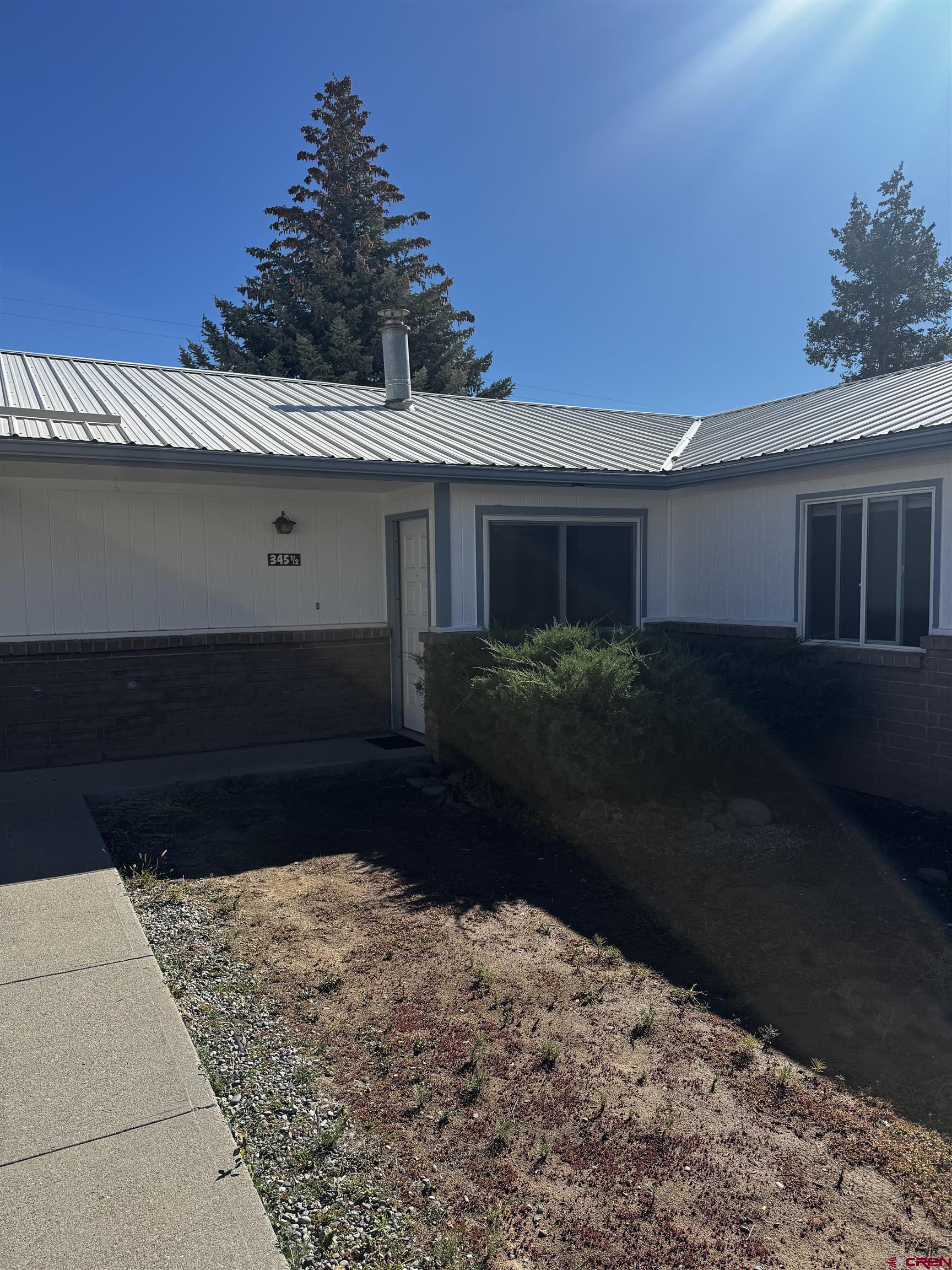 345 1/2 Northwest 4th Street Cedaredge, CO 81413 - Photo 3 of 28 a front view of a house with a yard