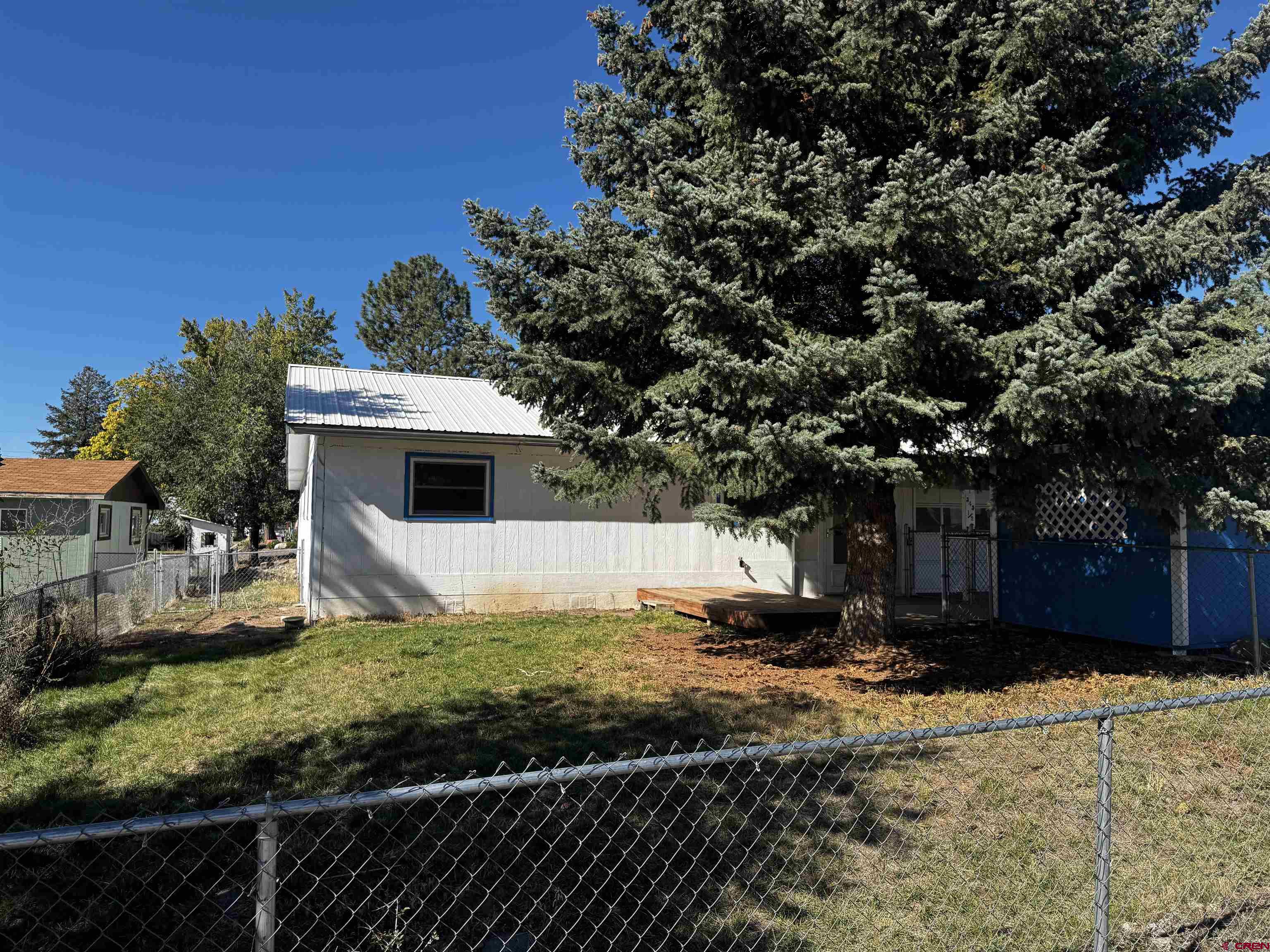345 1/2 Northwest 4th Street Cedaredge, CO 81413 - Photo 5 of 28 a view of a house with a yard