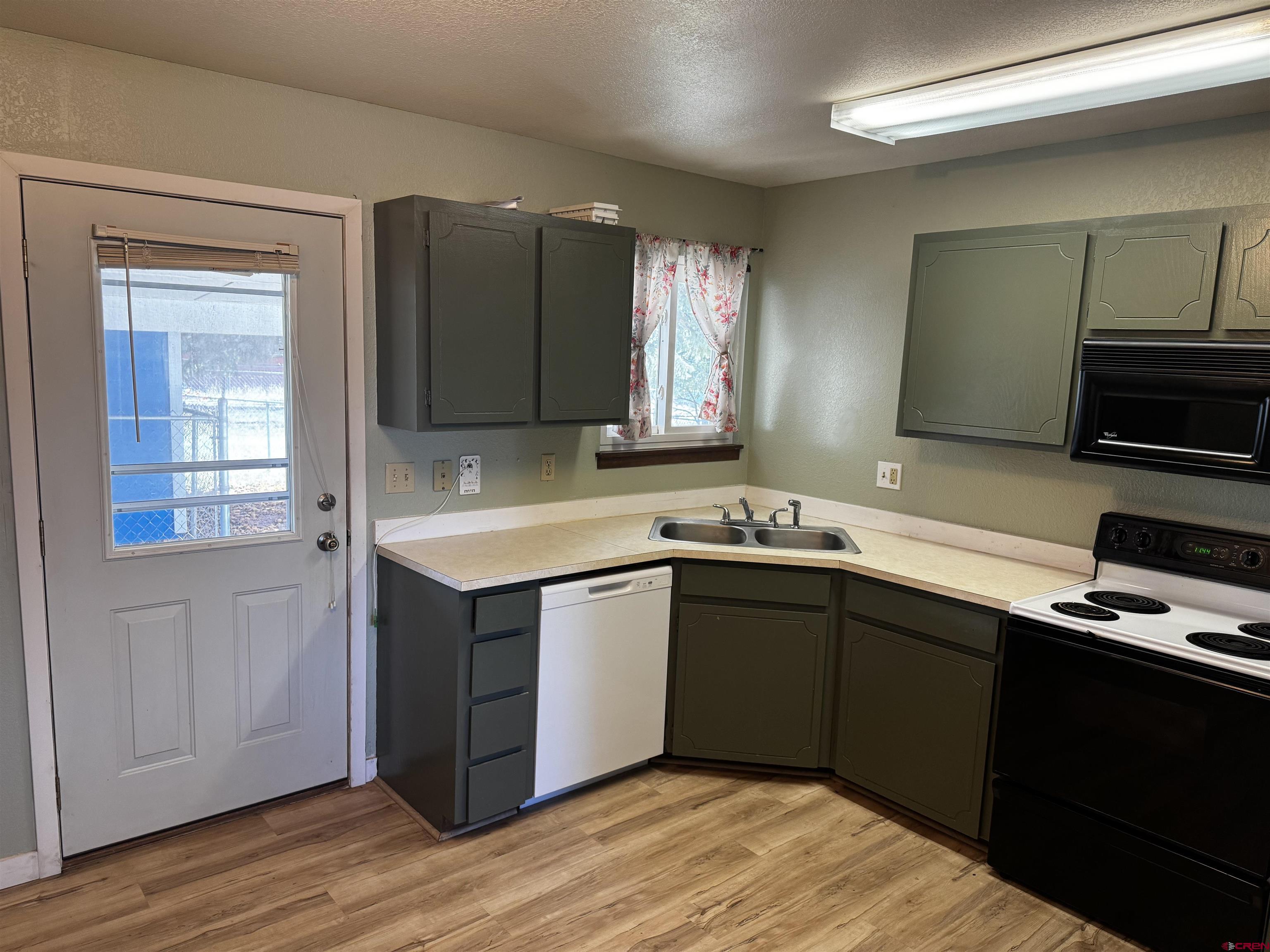 345 1/2 Northwest 4th Street Cedaredge, CO 81413 - Photo 10 of 28 a kitchen with a sink cabinets and wooden floor