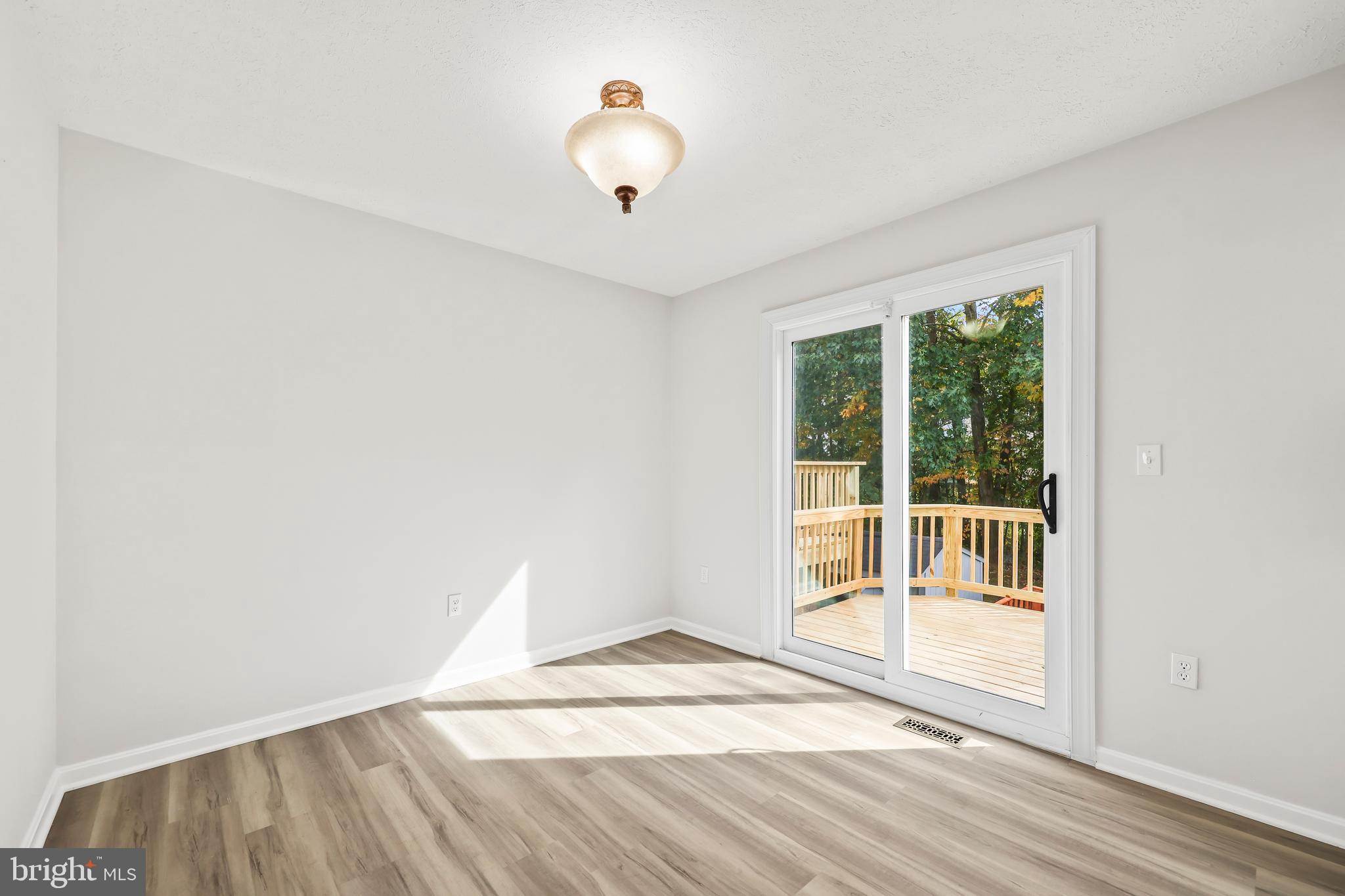 306 Kings Crest Drive Stafford, VA 22554 - Photo 11 of 41 a view of an empty room with wooden floor and a window