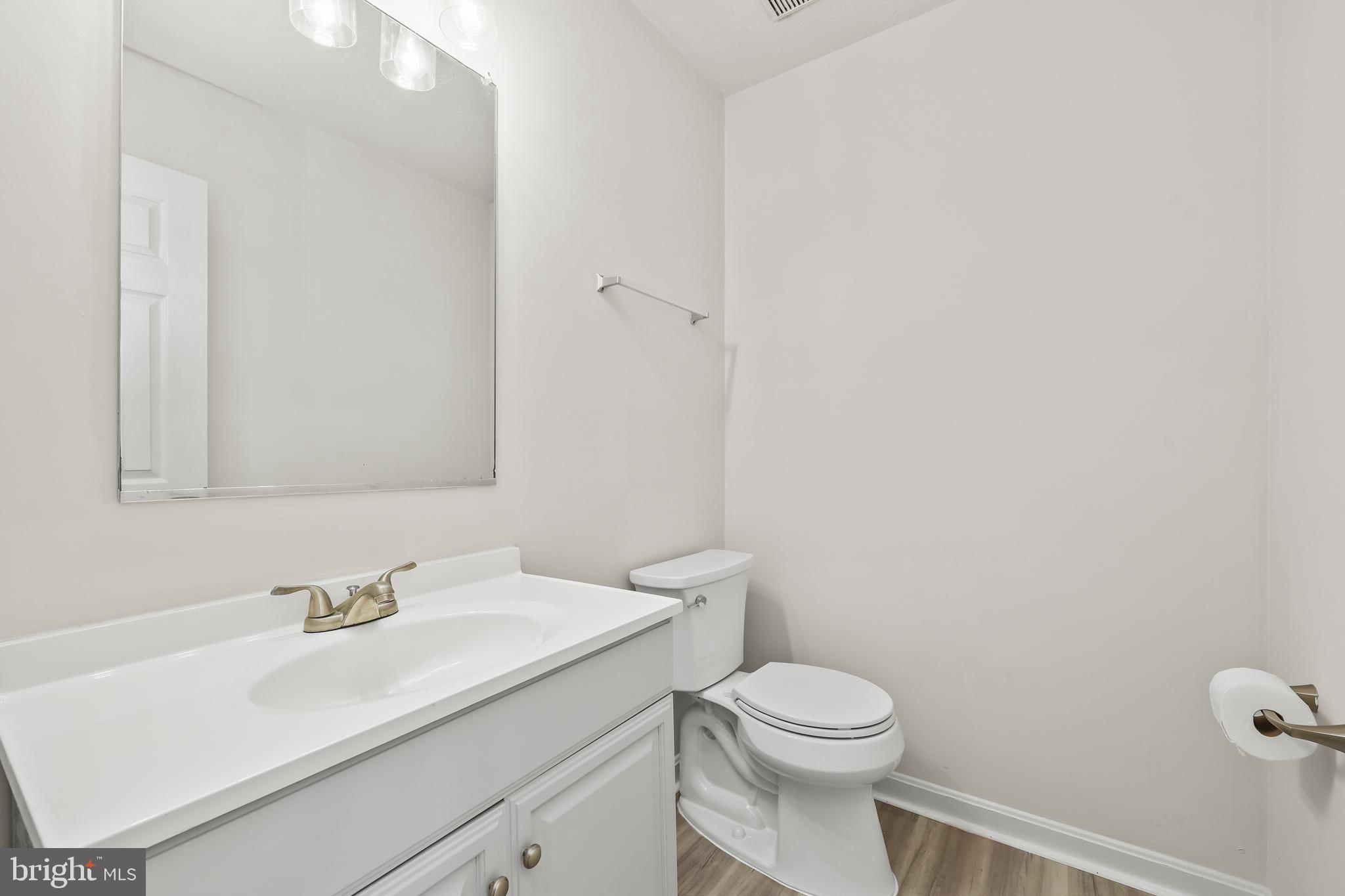 306 Kings Crest Drive Stafford, VA 22554 - Photo 12 of 41 a bathroom with a sink a toilet and a mirror