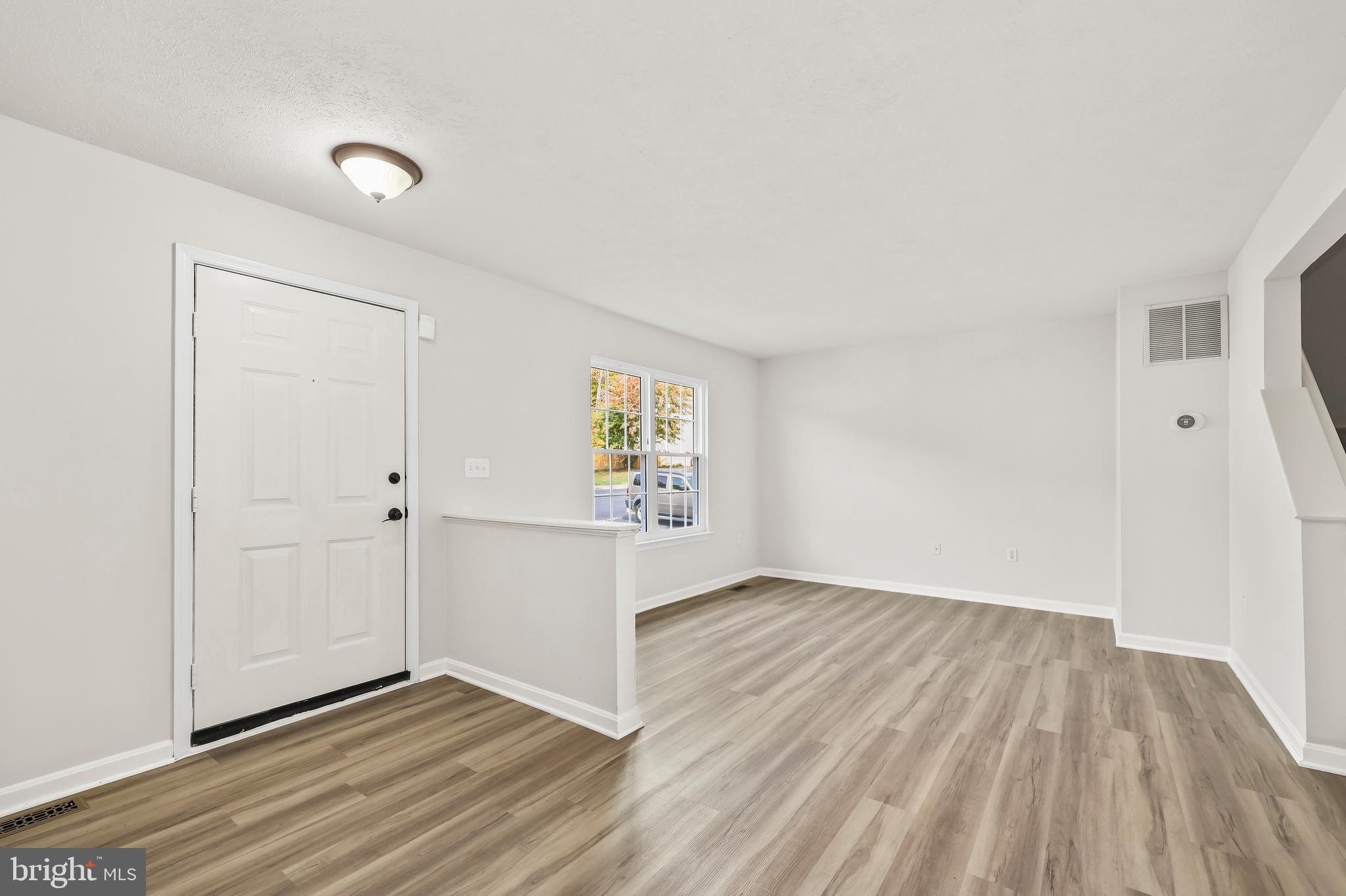 306 Kings Crest Drive Stafford, VA 22554 - Photo 14 of 41 an empty room with wooden floor and windows