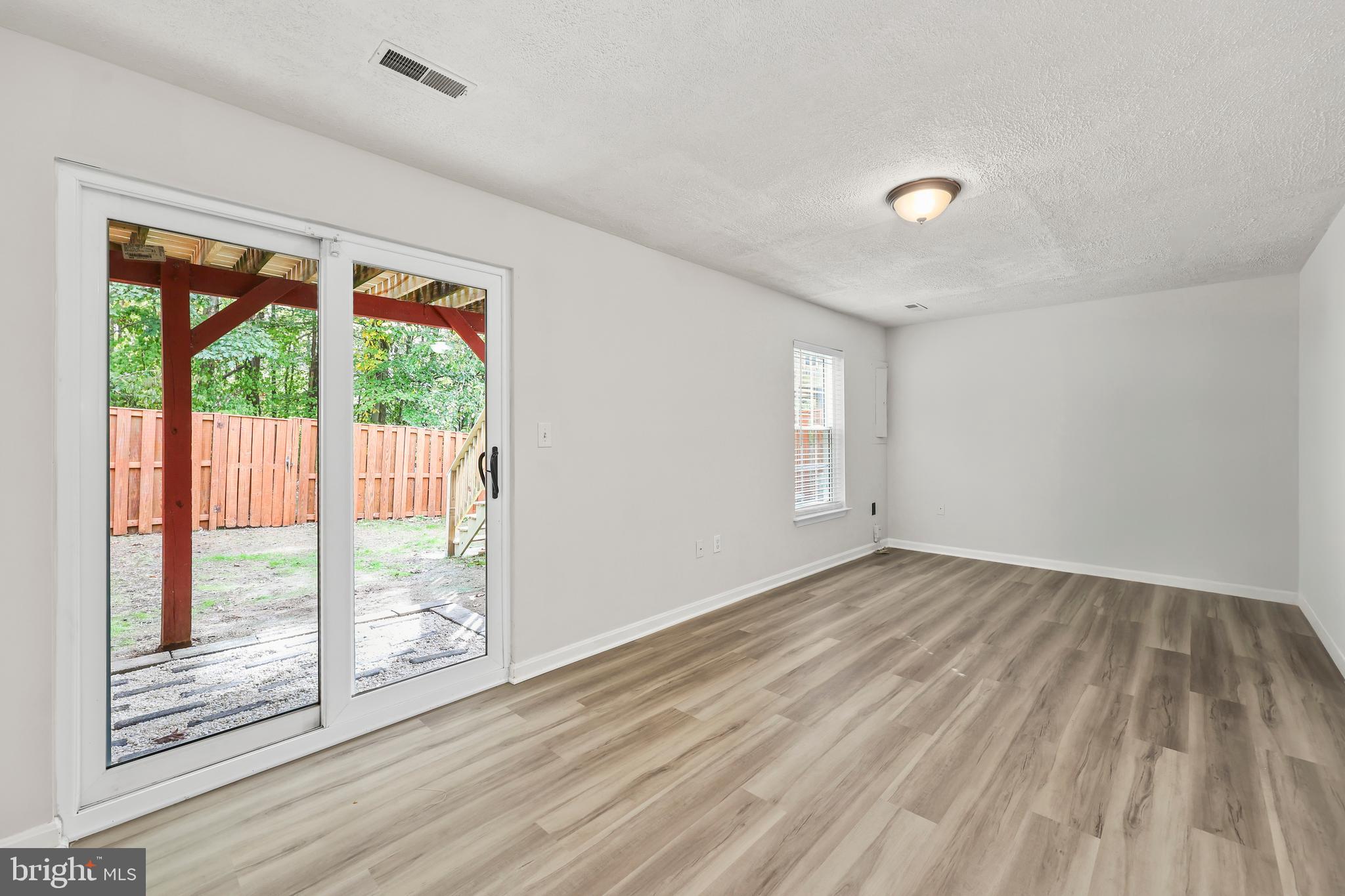 306 Kings Crest Drive Stafford, VA 22554 - Photo 20 of 41 an empty room with wooden floor and windows