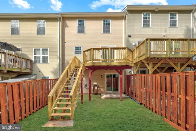 a view of backyard with a barn and a large tree