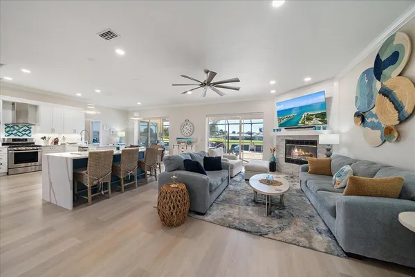 a living room with fireplace furniture and a chandelier