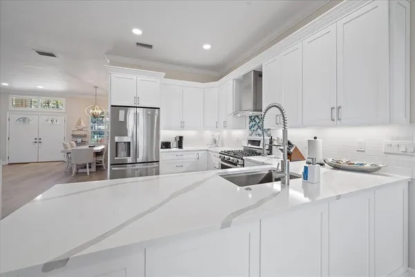 a kitchen with refrigerator and cabinets