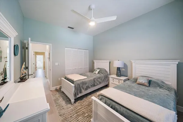 a bedroom with a bed and a large mirror