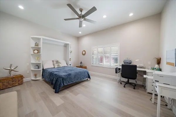 a spacious bedroom with a bed and a window