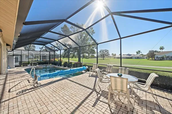 a view of a swimming pool with an outdoor seating