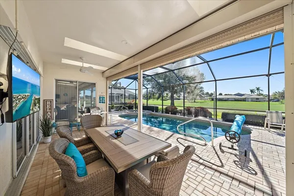 a view of a swimming pool with a porch and sitting area