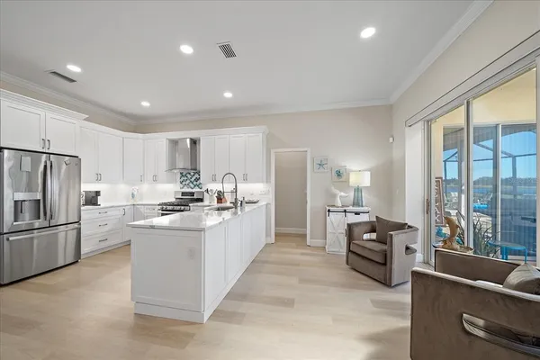a kitchen with refrigerator and furniture