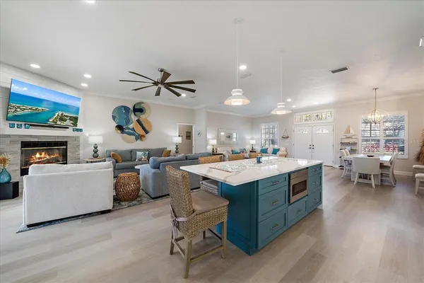 a kitchen with a stove a refrigerator and a fireplace