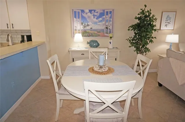 a view of a dining room with furniture and a potted plant