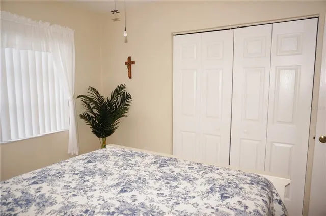 a bedroom with a bed and a window