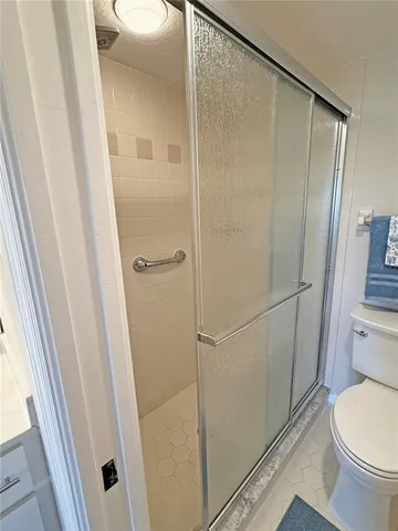 a bathroom with a shower and a toilet