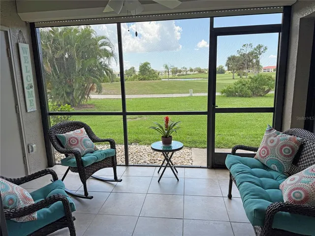 a living room with a large window and a table