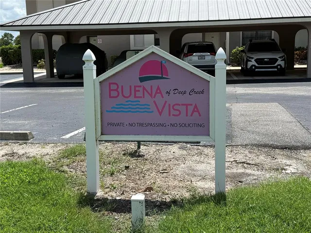 a view of a street with cars parked in front of it