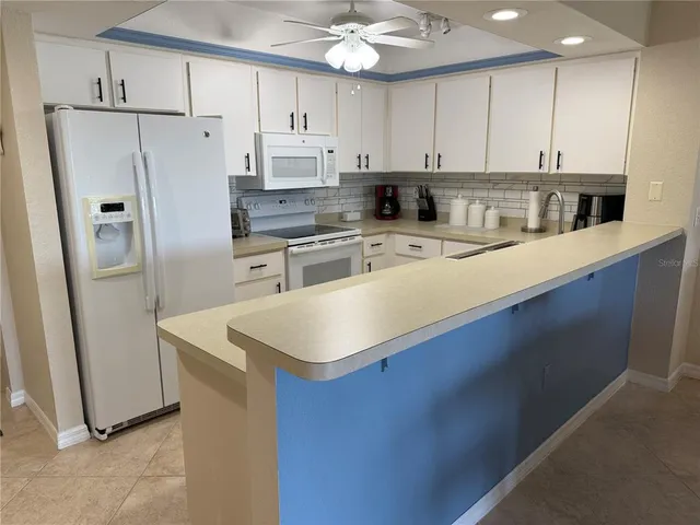 a kitchen with stainless steel appliances a refrigerator sink and cabinets