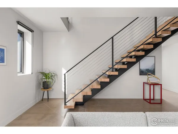 a living room with furniture a flat screen tv and a floor to ceiling window