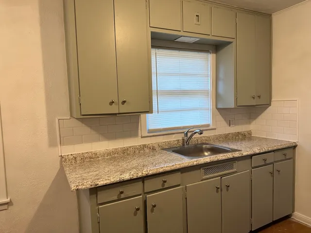 a kitchen with granite countertop cabinets and sink
