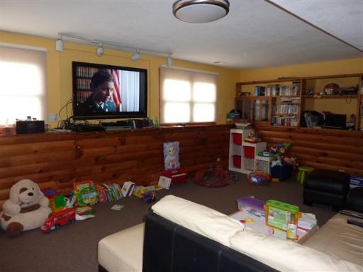 607 Surryse Road Lake Zurich, IL 60047 - Photo 13 of 15 a living room with furniture a flat screen tv and a floor to ceiling window