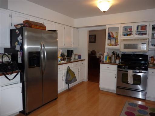 607 Surryse Road Lake Zurich, IL 60047 - Photo 6 of 15 a kitchen with stainless steel appliances granite countertop a refrigerator a stove and a sink with wooden floor