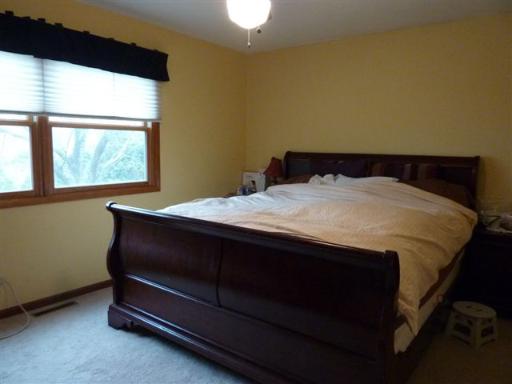 607 Surryse Road Lake Zurich, IL 60047 - Photo 8 of 15 a bed sitting in a bedroom next to a window