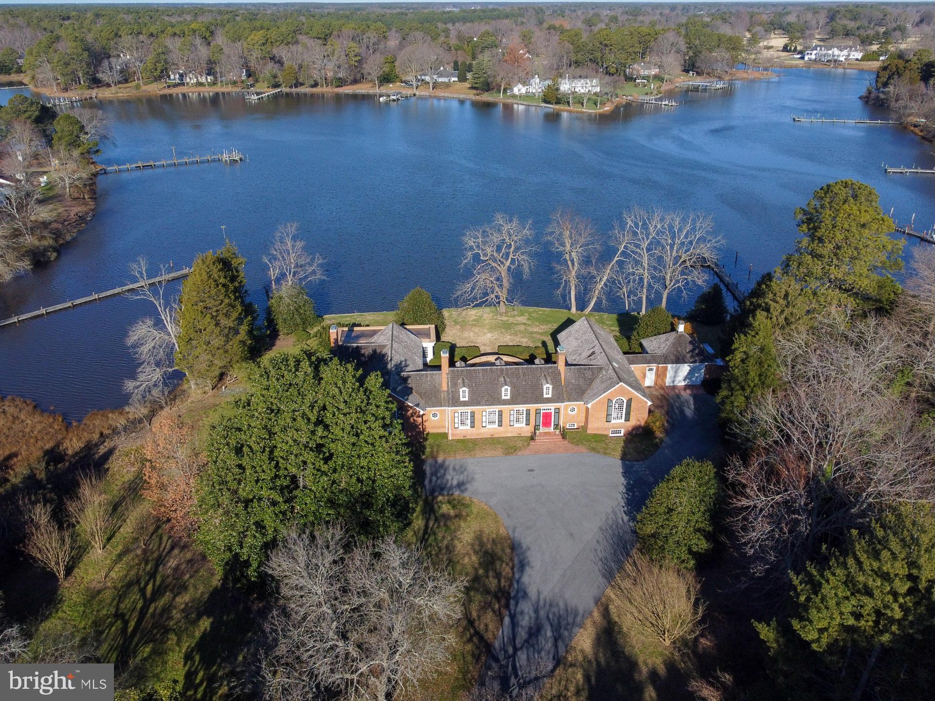 an aerial view of a house with a yard lake view