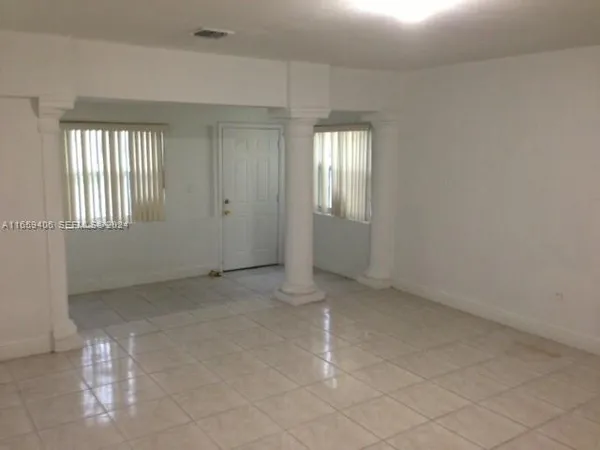 a view of an empty room with windows